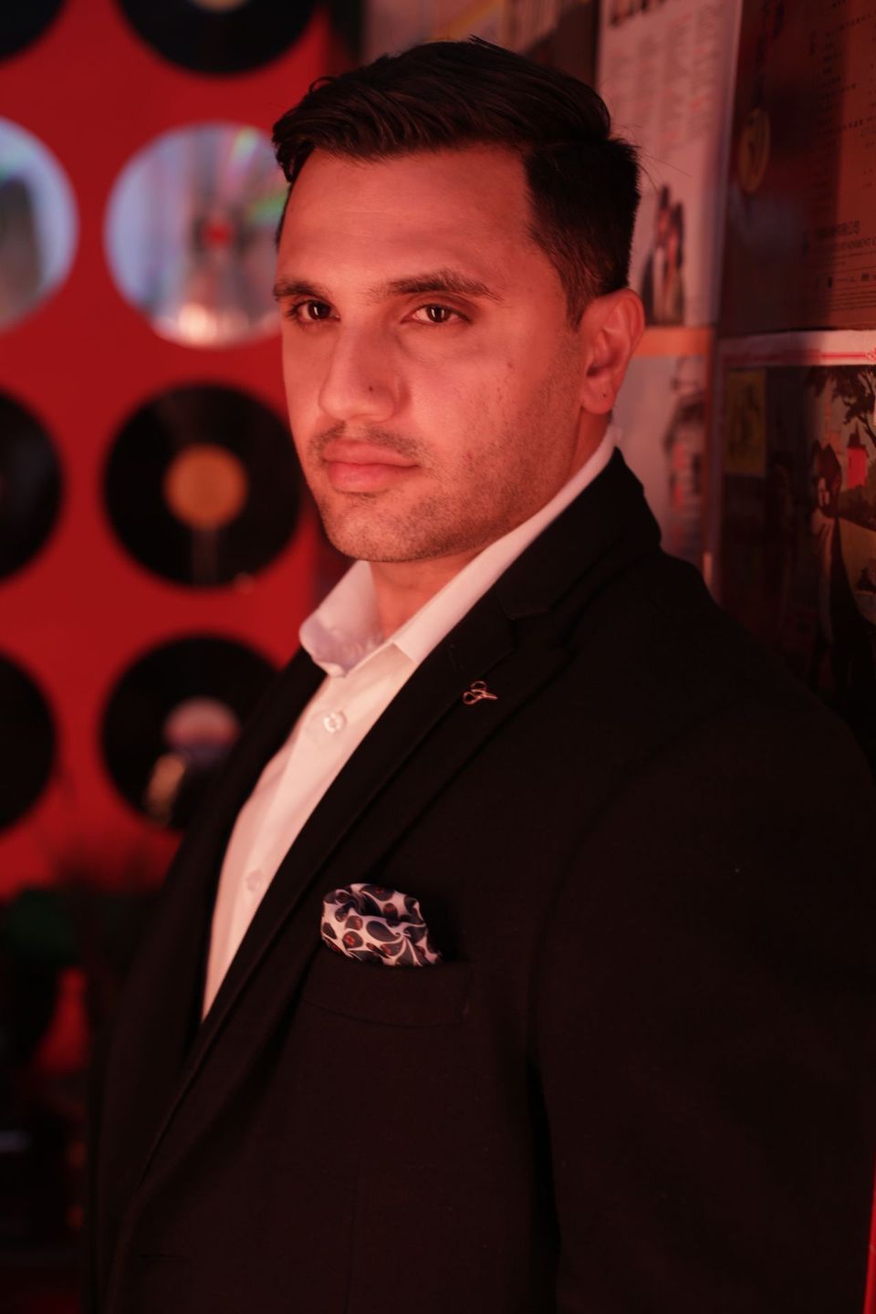 Suited actor under red stage light