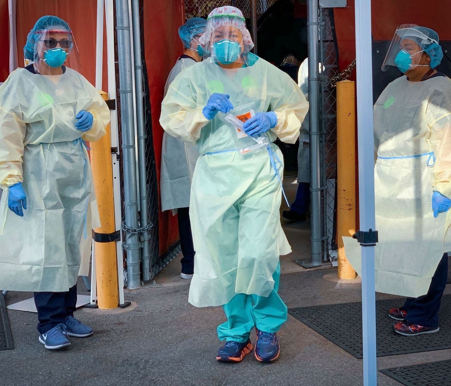 Figure in protective gear photographed through an industrial doorway