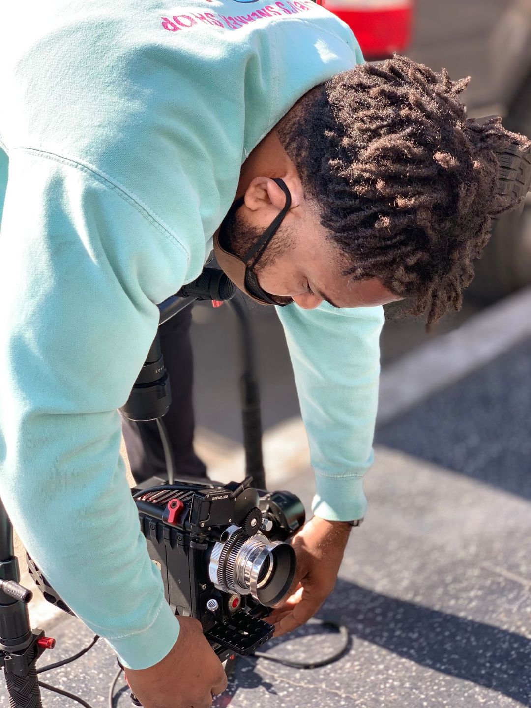 Videographer crouching low to line up a shot