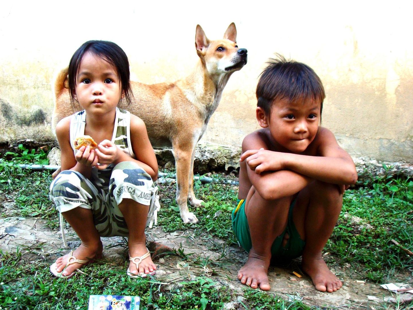 Children hugging their dog
