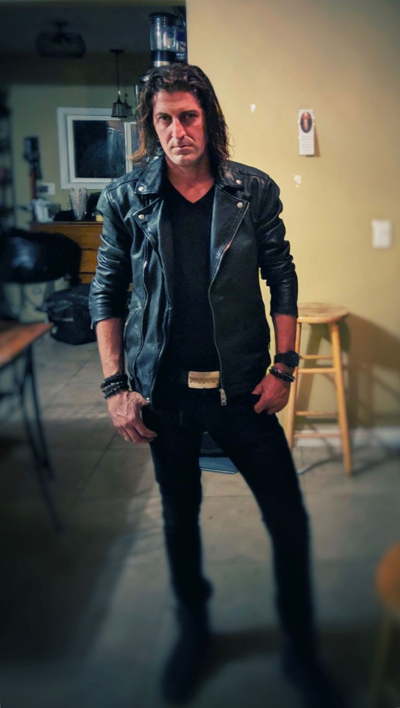 Man in a leather jacket photographed indoors