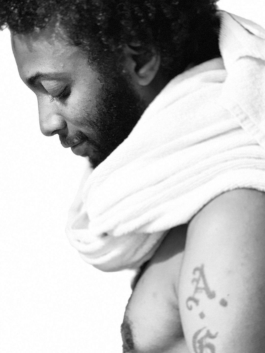 Intimate black and white portrait of a man with a towel over his shoulder