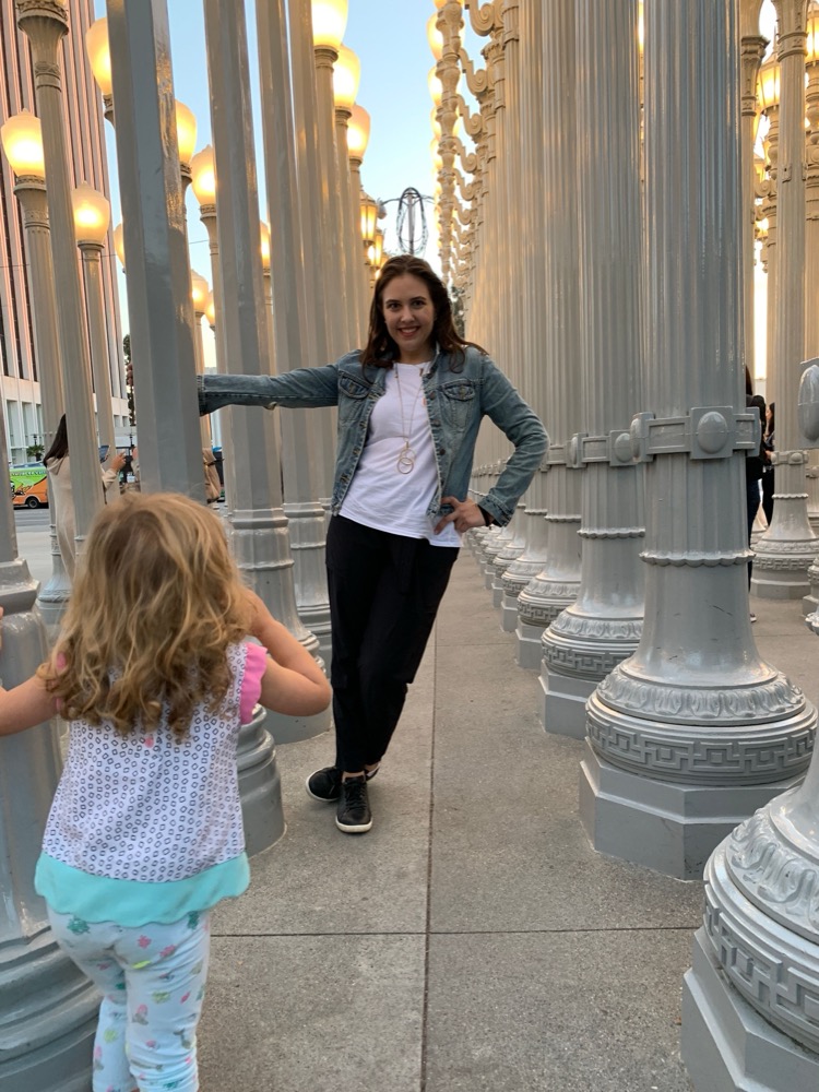 Laura Tornga and her daughter among the lampposts of Urban Light at LACMA